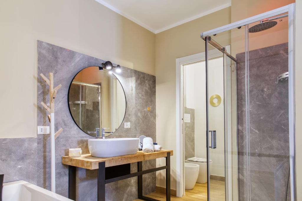 a bathroom with a sink and a shower at Medea Mondello Suite in Mondello