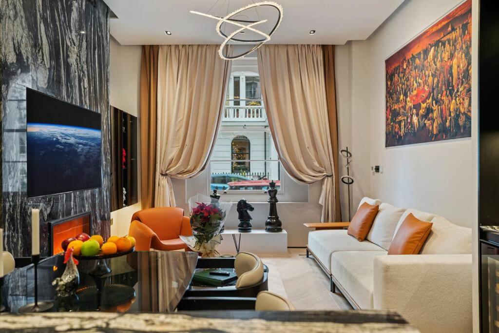 a living room with a couch and a table at Unique 1 Bedroom Luxury Haven In Central London in London