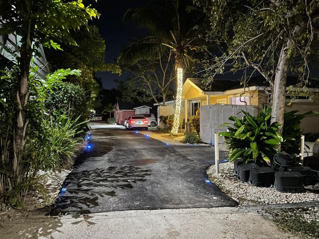 a street at night with a car parked on the road at Sandelwood Studios' in Nassau