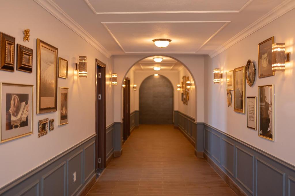 a hallway in a building with pictures on the walls at AN PHÚ Home in Da Lat