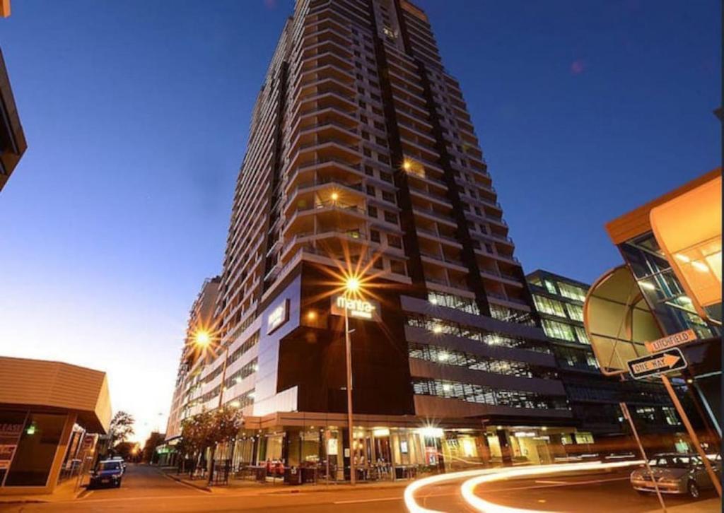 a tall building with a street in front of it at 18th Floor Seaview Exec Style King Bed Apartment in Darwin