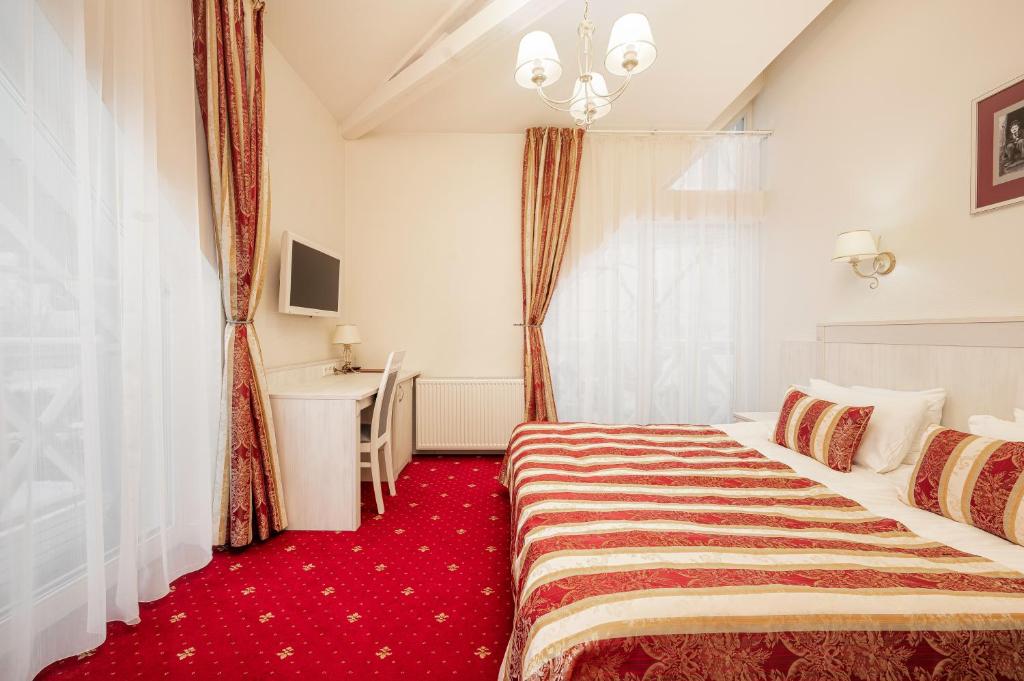 Postel nebo postele na pokoji v ubytování Art Hotel