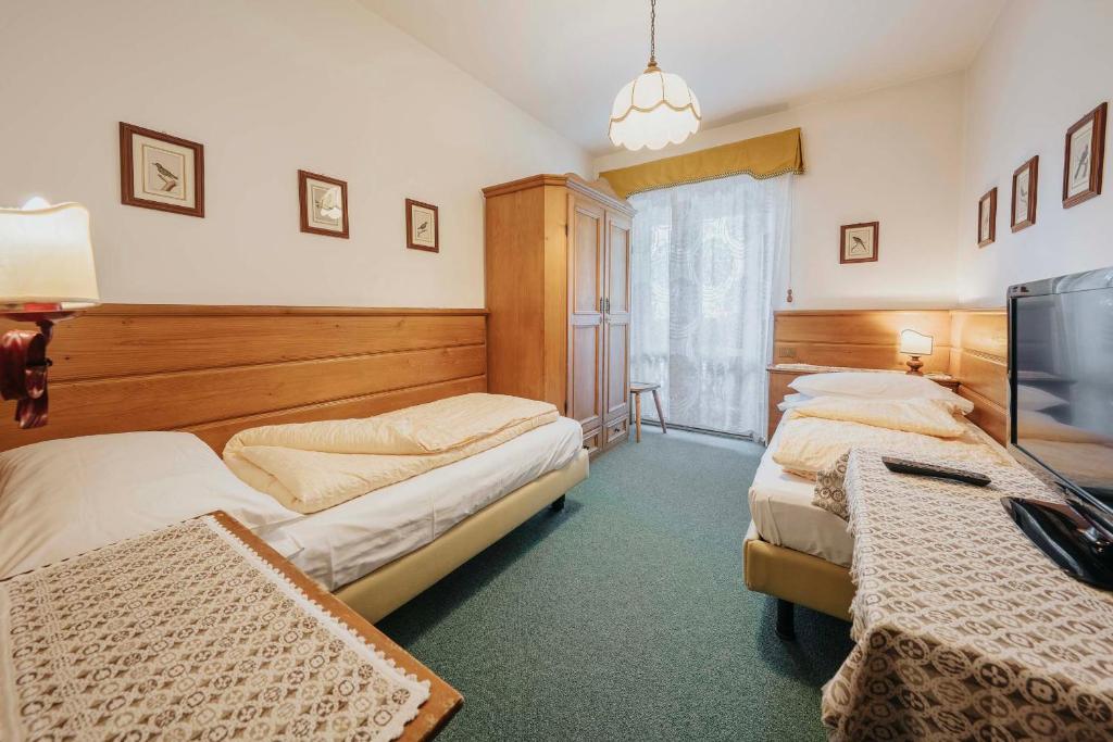 Кровать или кровати в номере Hotel Menardi