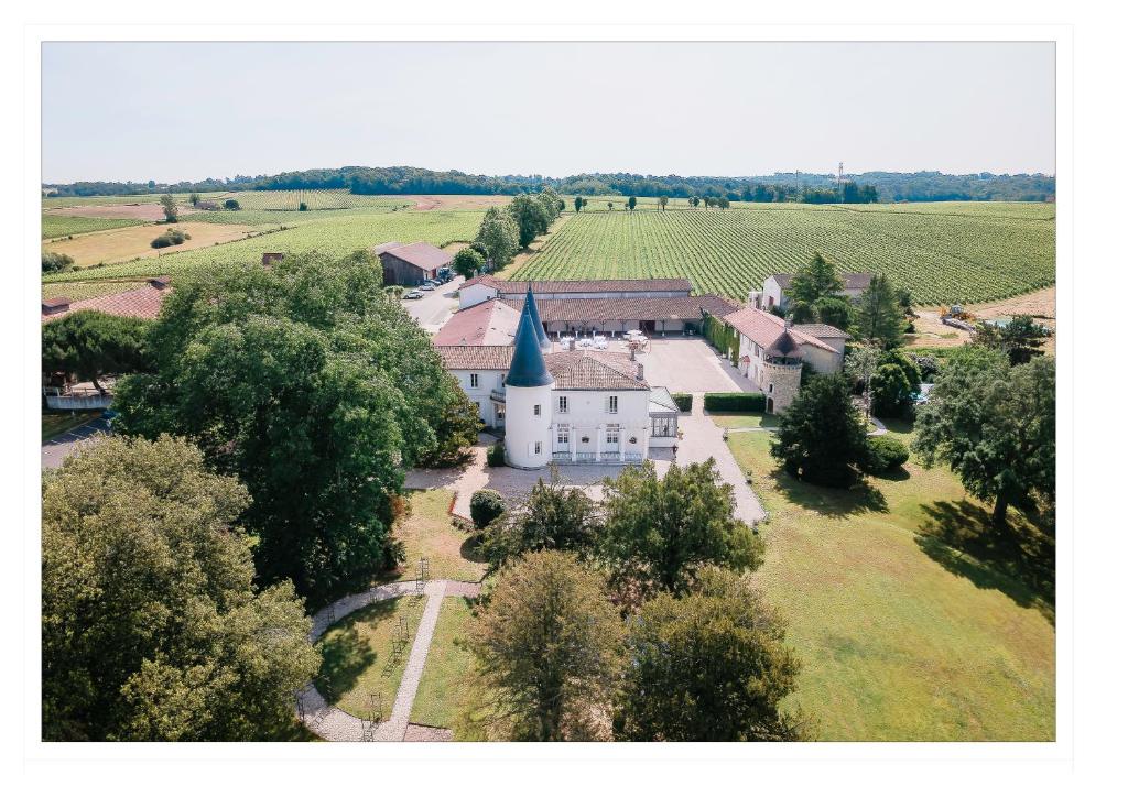 an aerial view of a small village with a church at Gîte Château de Seguin in Lignan-de-Bordeaux