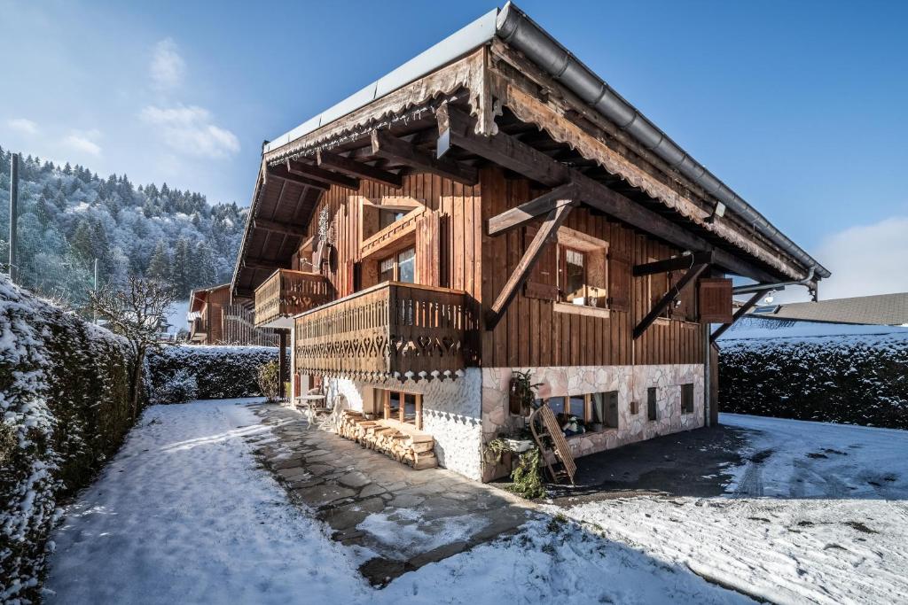 a log cabin with snow on the ground at Chalet Sun River - 8 pers in Morzine