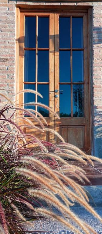 a building with a wooden door and a window at Casas de Epoca -Serendipia in Charbonier