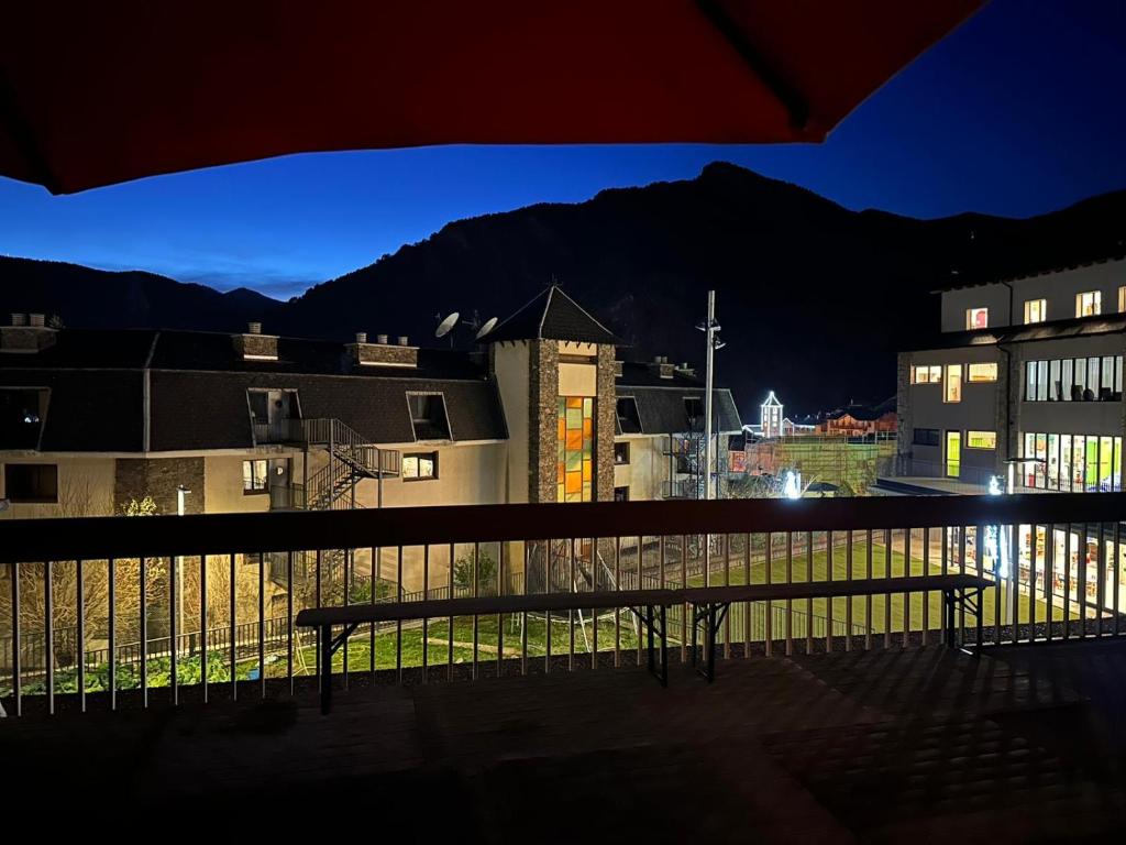a bench sitting on top of a balcony at night at appartement Terrasse 1 chambre ORDINO HUT3-008298 in Ordino