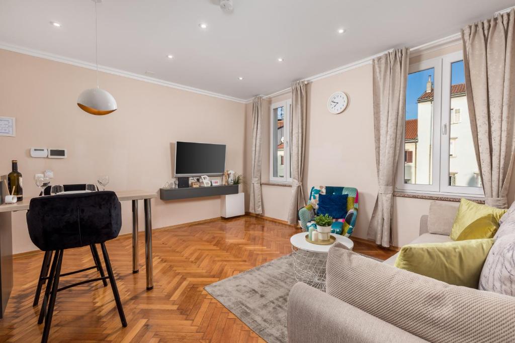 a living room with a couch and a table at Apartments Neo in Rijeka