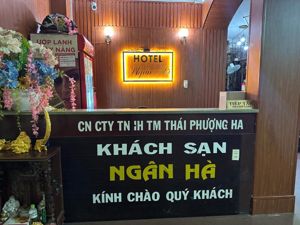 a sign for a hotel on the wall of a store at Khách Sạn Ngân Hà in Ho Chi Minh City