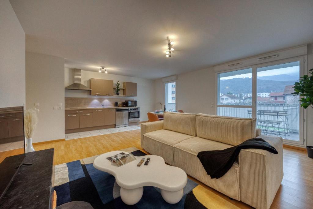 a living room with a couch and a table at l'Éclat Contemporain in Seyssinet-Pariset