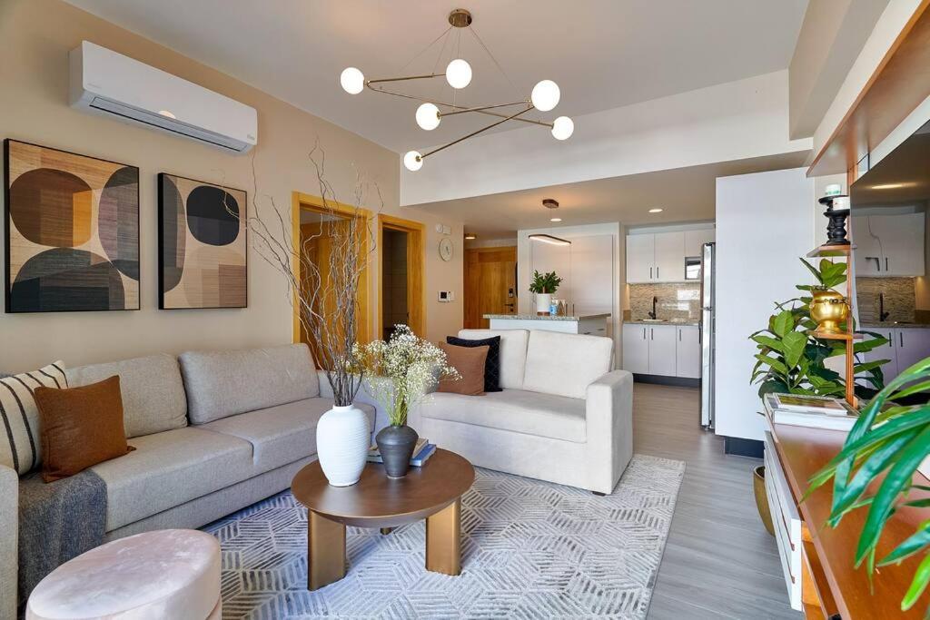 a living room with a couch and a table at Modern and cozy 1 bedroom apartment in Santo Domingo
