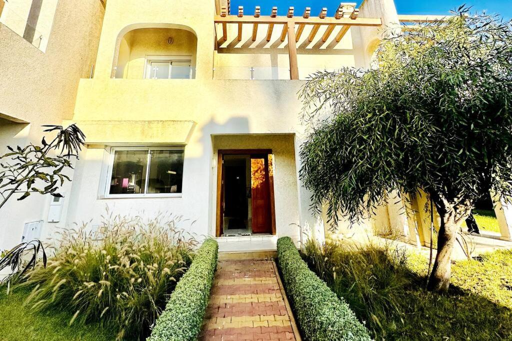 a house with a walkway in front of a building at Oasis de Sérénité en Bord de Mer in Casablanca