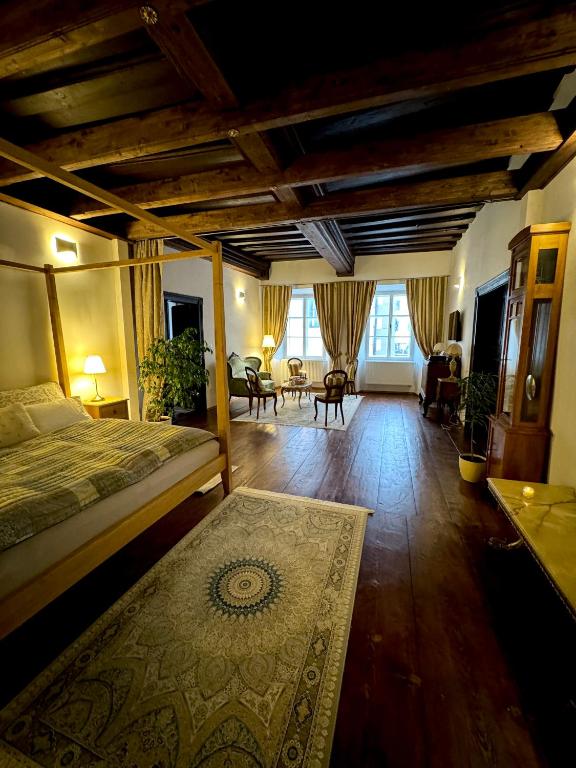 a bedroom with a bed and a living room at Maison Český Krumlov in Český Krumlov