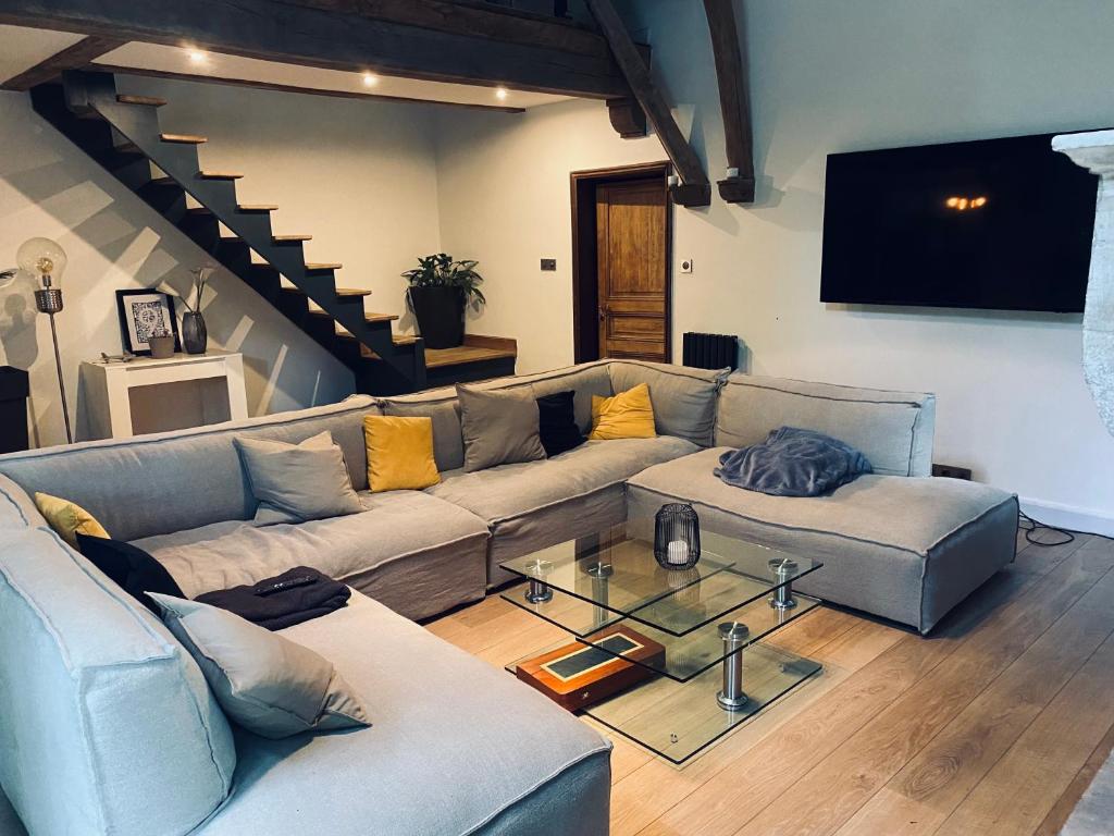 a living room with a couch and a table at Oak Wood - Olympic Villa in La Queue-lès-Yvelines