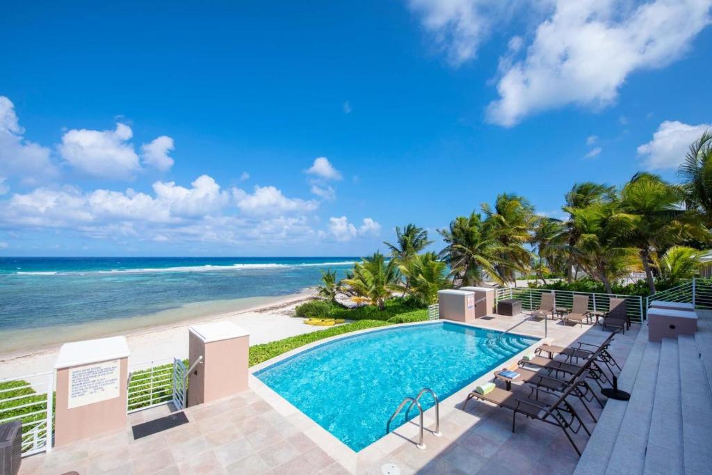 a view of the beach and swimming pool at the resort at Coral Kai home in Driftwood Village