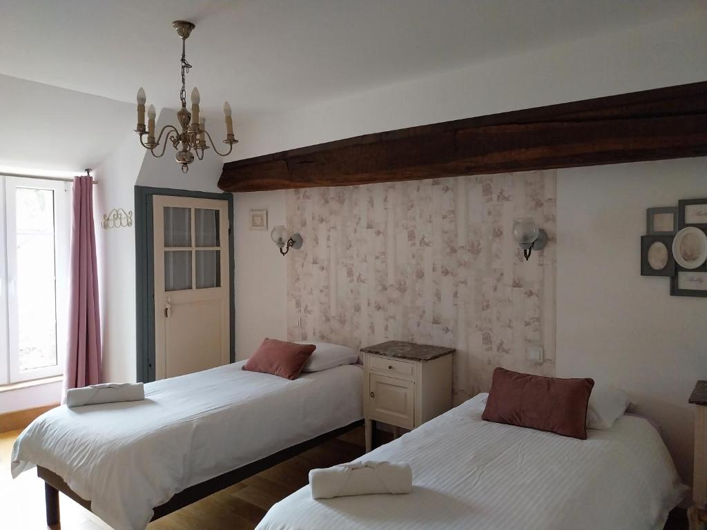 Postel nebo postele na pokoji v ubytování La Maison des Maîtres de Forge