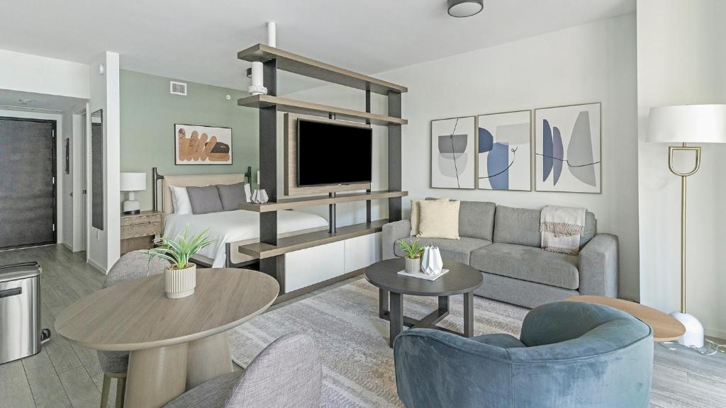 a living room with a couch and a tv at The Bayfront in Miami