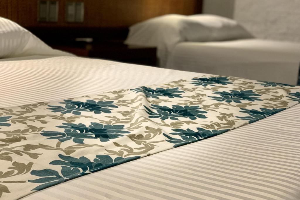 Postel nebo postele na pokoji v ubytování Hotel Puerta Chichen