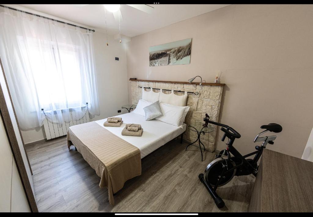a bedroom with a bed and a bike in it at My hive in Cascina