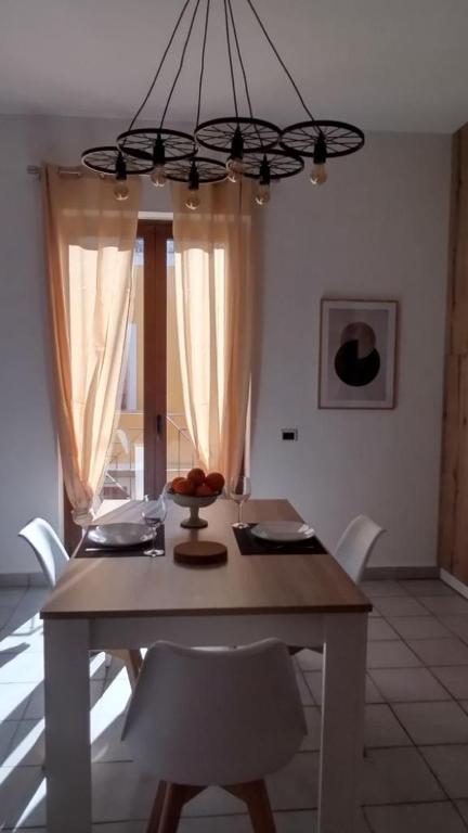 a dining room table with chairs and a chandelier at LechicchediLampedusa in Lampedusa