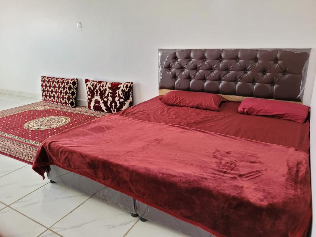 a bedroom with a large bed with a leather headboard at درة نجد ببريده 2 in Buraydah