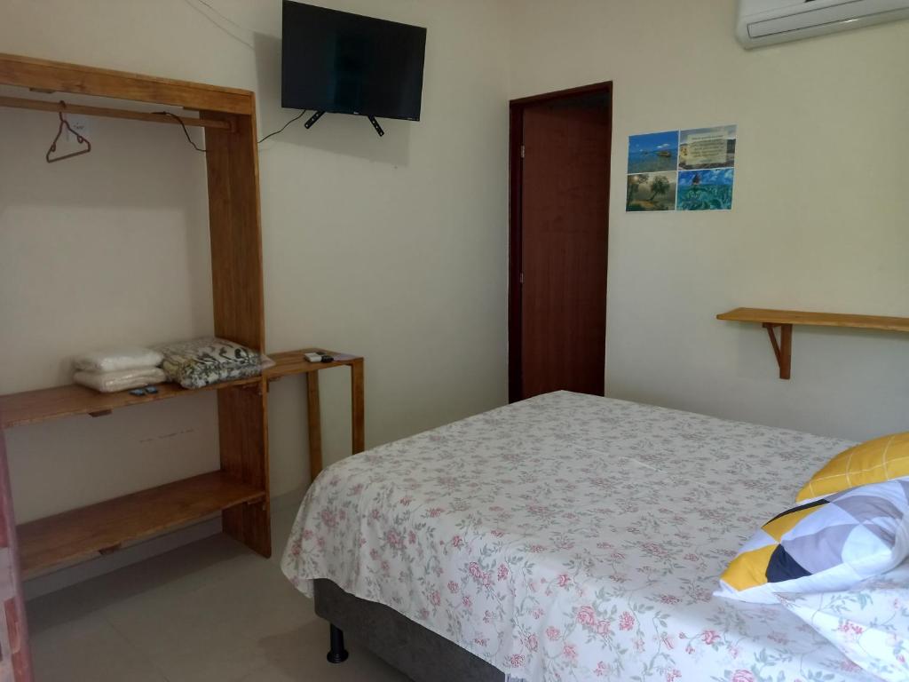 a bedroom with a bed and a flat screen tv at Propriedade patolo in São Miguel dos Milagres