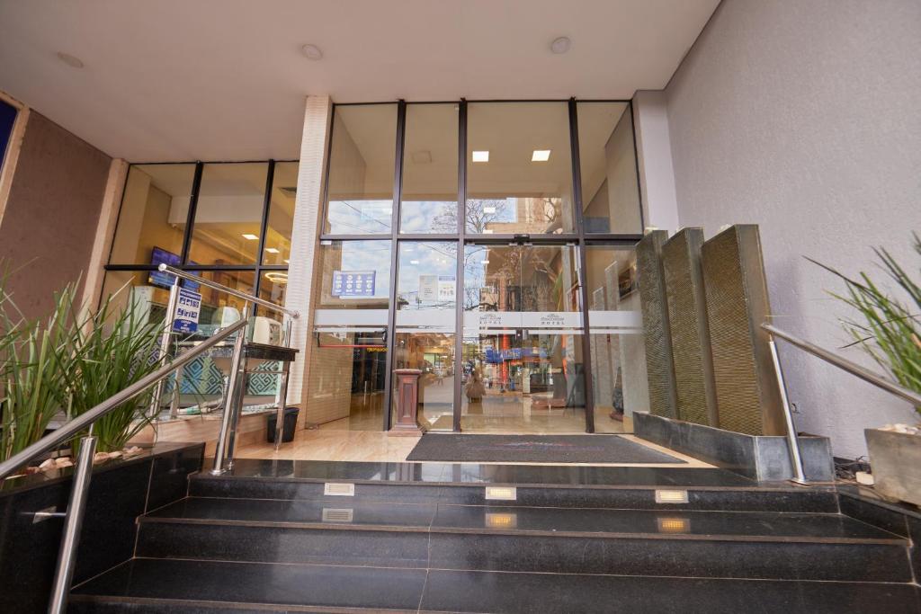 a staircase leading to a building with glass doors at Howard Johnson Ciudad del Este in Ciudad del Este