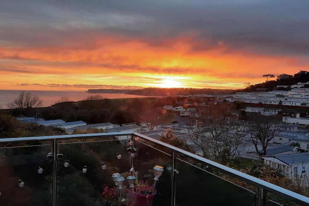 a view of a sunset from a balcony at Brixham View House in Torquay