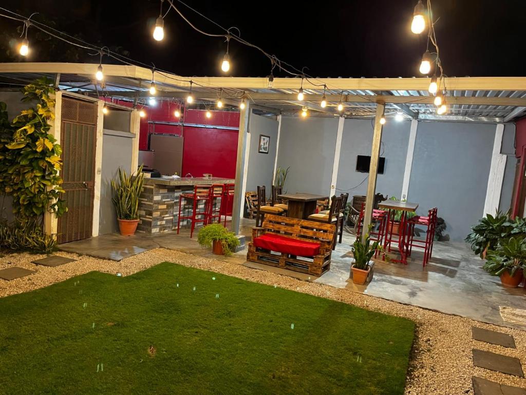 a patio with a table and chairs and lights at Gamboa Lodging 1 in Liberia