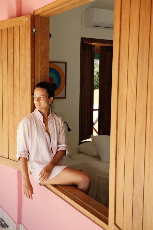 a woman sitting in front of a mirror at Seaflower Boutique lodge in Providencia