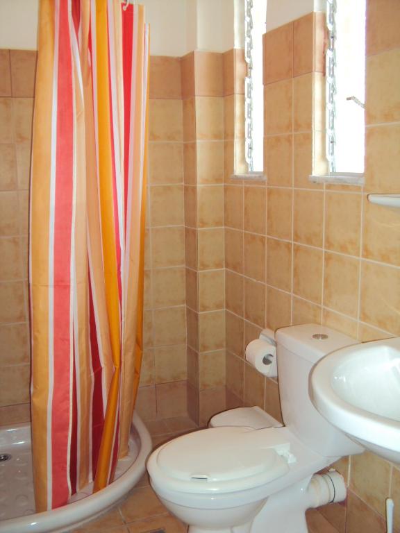 a bathroom with a toilet and a sink at Galini Studios and Apartments in Lassi