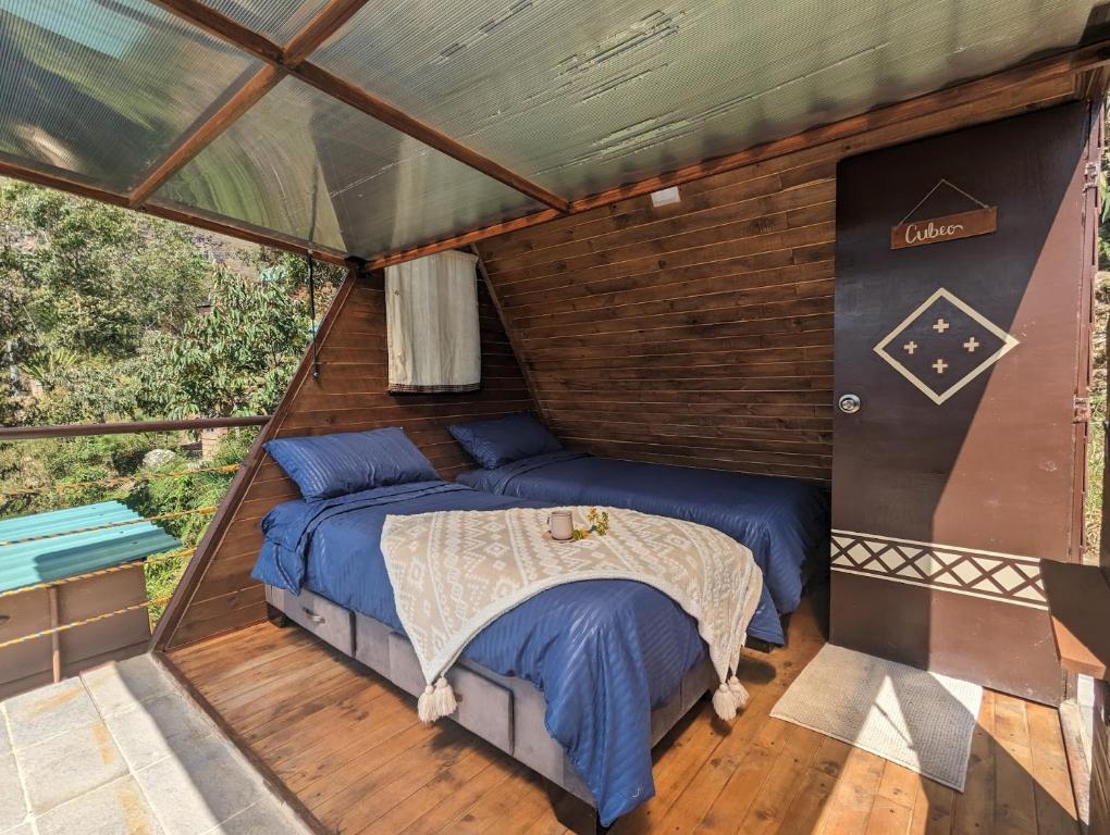 a bedroom in a tent with a bed in it at Mamaterra Glamping in Macanal
