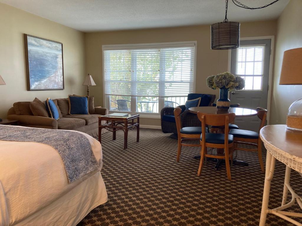 a hotel room with a bed and a living room at Michillinda Lodge Resort in Whitehall