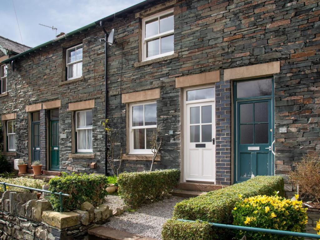 a brick house with a blue door and windows at 2 Bed in Keswick SZ009 in Keswick