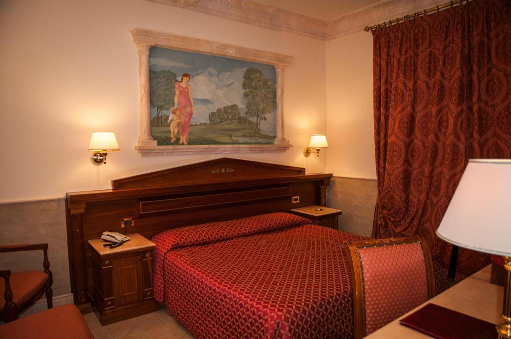 Postel nebo postele na pokoji v ubytování Hotel Palladium Palace