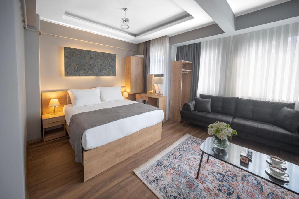 a hotel room with a bed and a couch at StayHub in Istanbul