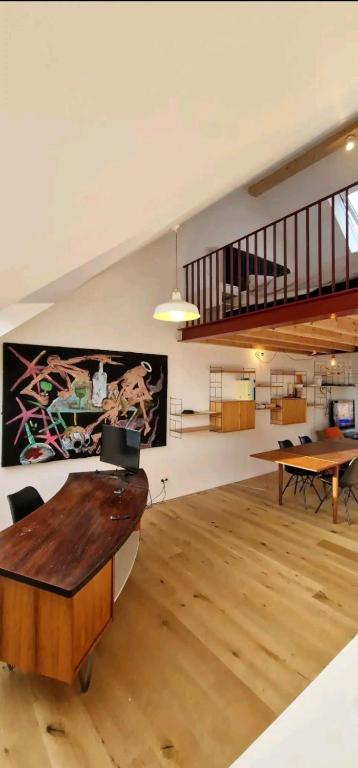 a large room with a wooden table and a wooden floor at Penthouse lumineux in Brussels