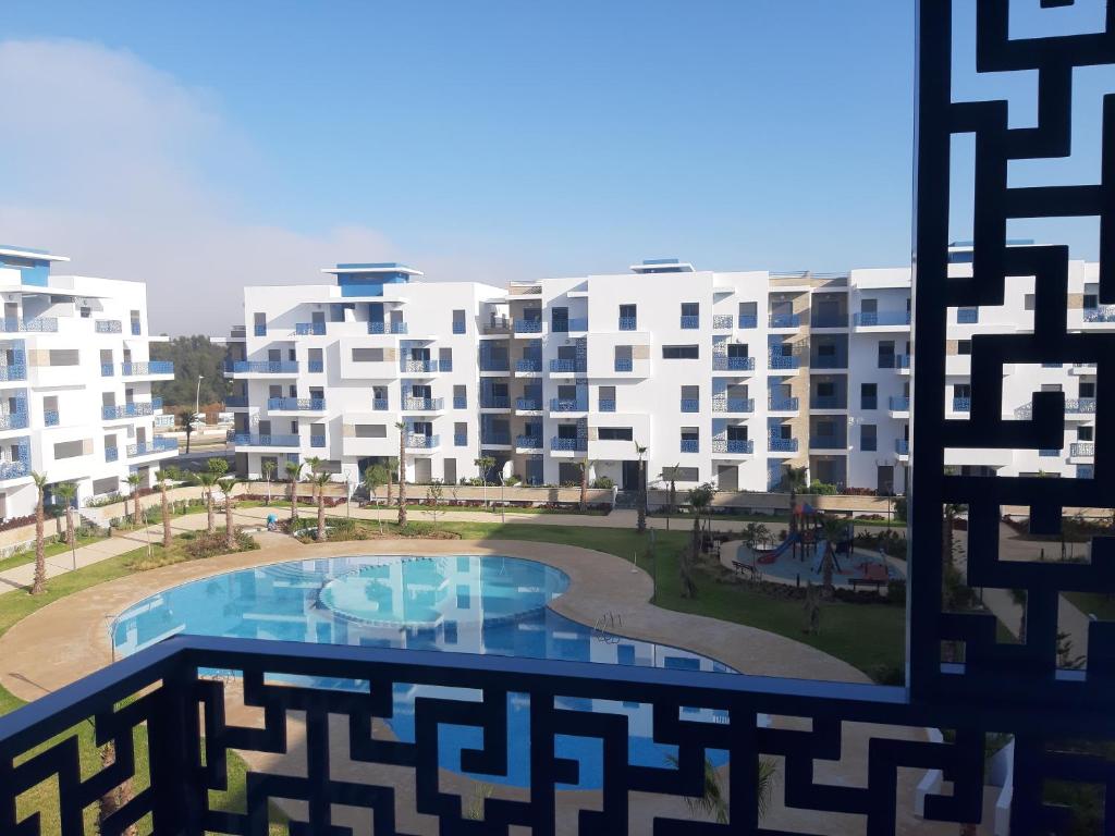 a view from a window of a building with a swimming pool at Appartement de Luxe MARTIL COSTA MAR Pour Familles in Martil