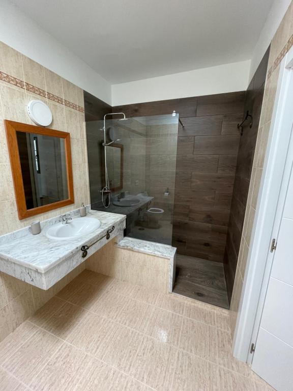 a bathroom with a sink and a shower at Casa Mic&ele in Playa Blanca