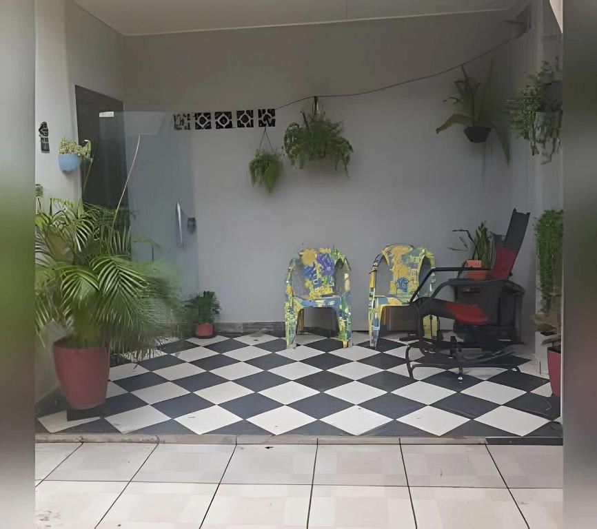 um quarto com duas cadeiras e um piso xadrez em Pousada Souza Familiar em Porto Velho
