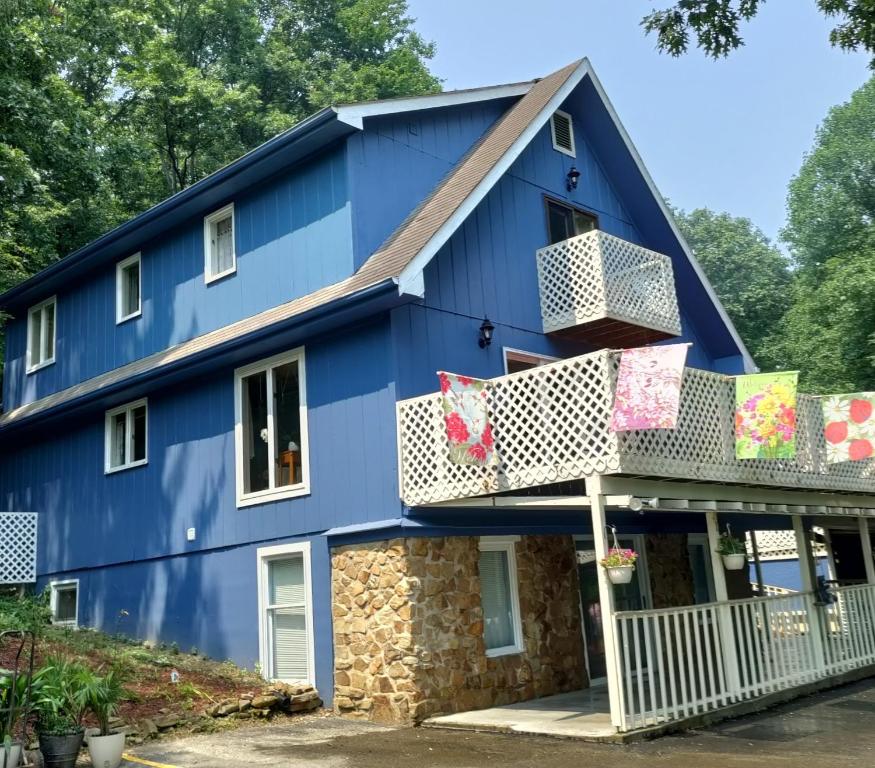 a blue house with a balcony at Lil Black Bear Inn in Nashville