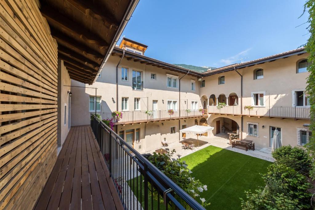 an apartment balcony with a view of a courtyard at Colle Ameno Room and Breakfast in Rovereto