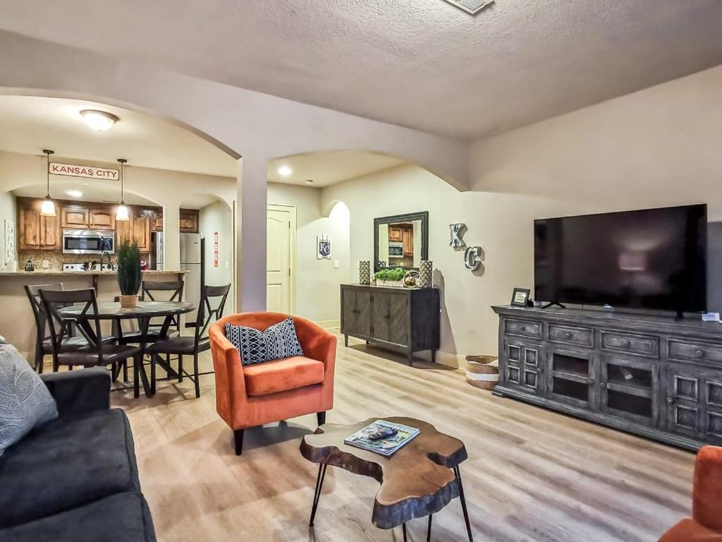 uma sala de estar com um sofá, uma televisão e uma mesa em Large Plaza 2BR BTH em Kansas City