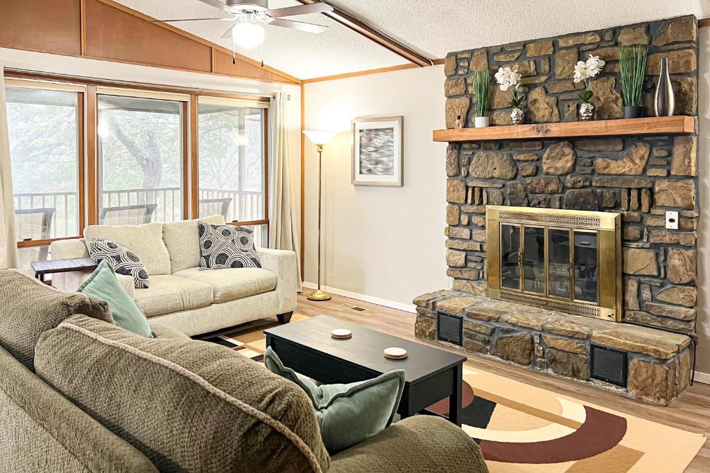 a living room with a couch and a fireplace at The Lost Bridge Lakehouse in Garfield