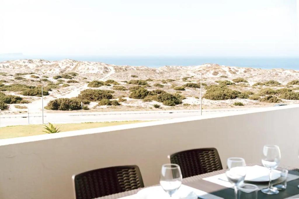 a table and chairs with a view of the desert at Sea View Baleal in Peniche