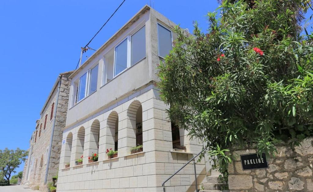a brick building with windows and a tree at Apartments Aurora Adriatica in Brist