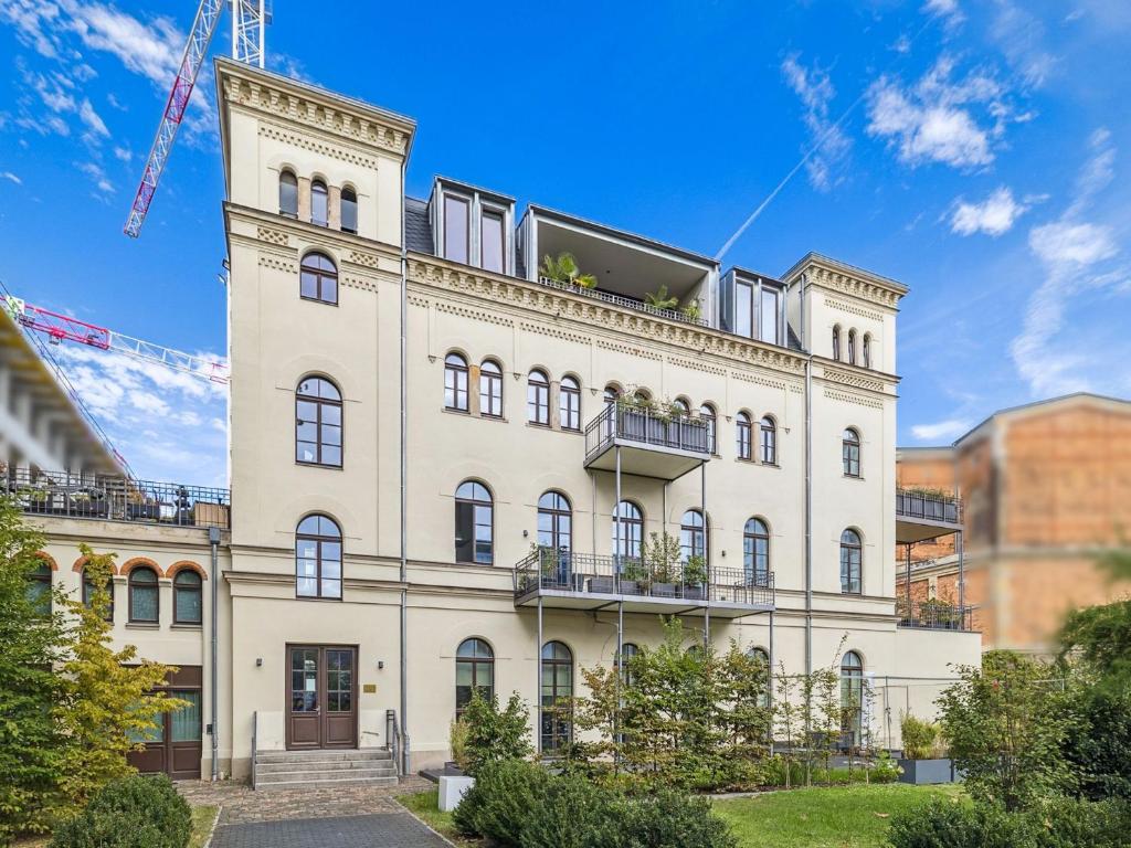Hotel Cityloft Gold - Zentrum / 105qm / inkl. Parkplatz / Netflix, a large white building with a tower at Cityloft Gold - Zentrum / 105qm / inkl. Parkplatz / Netflix in Leipzig