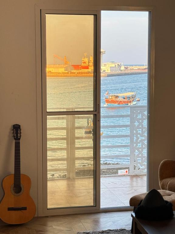 a door to a room with a view of the ocean at Muttrah Souq and Sea View in Muscat
