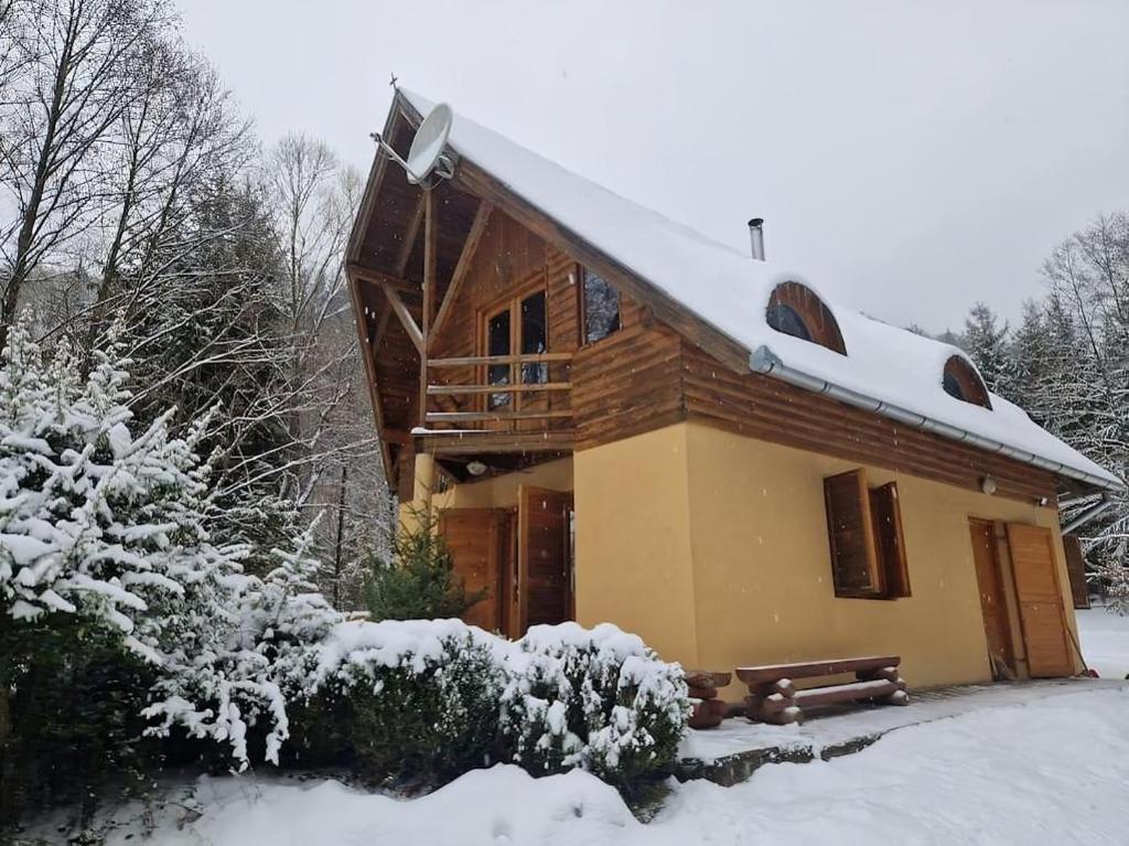 a log cabin with snow on the roof at ForrestHouse in Zetea