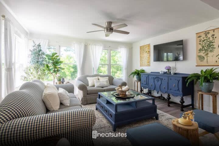 a living room with a couch and a table at French Riviera-Style Country Waterfront Cottage in Sparta